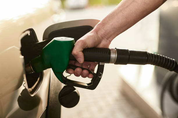 istock Crop man refueling car at station 1475811383