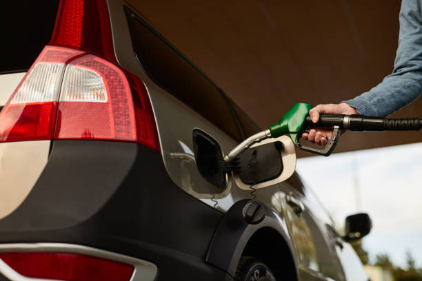 istock Crop anonymous man refueling vehicle at filling station 1475811433