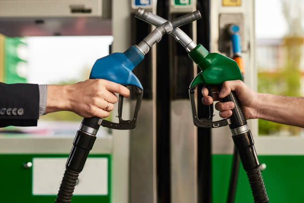 istock Crop men crossing gas pump nozzles 1475811492