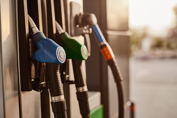 istock Hoses hanging on gas pump 1475811496
