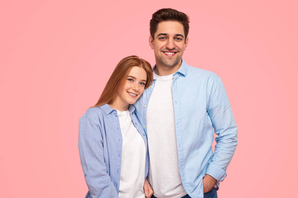 istock Glad couple in similar clothes looking at camera 1475812945