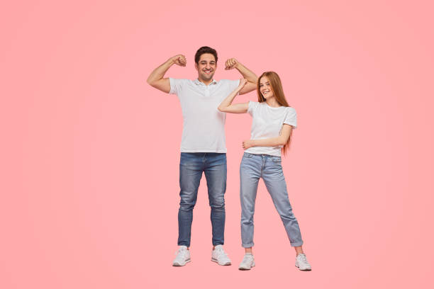 istock Strong young couple showing muscles 1475813181
