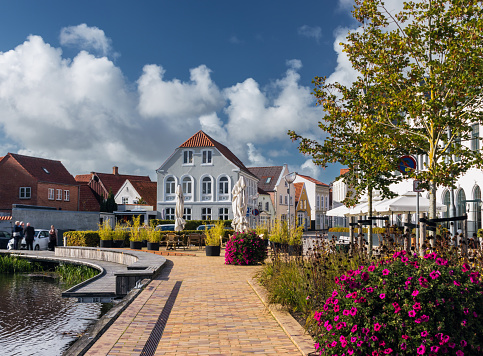 Cityscape of Tønder, Southern Denmark (Syddanmark). Lake near the old town with flowers around it.
