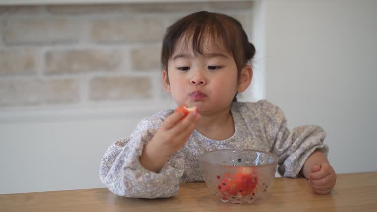 girl eating strawberry