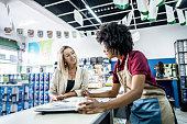 Saleswoman attending a customer at a paint store