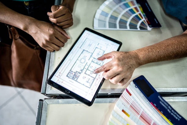 Saleswoman's hands using the digital tablet at a pant store