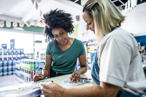 istock Saleswoman attending a customer at a paint store 1475816277