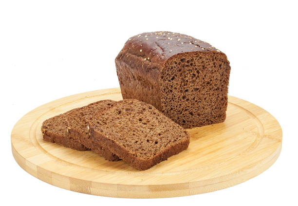 istock Rye bread slices over wooden board isolated over white background. Flat lay, top view. 1475817427