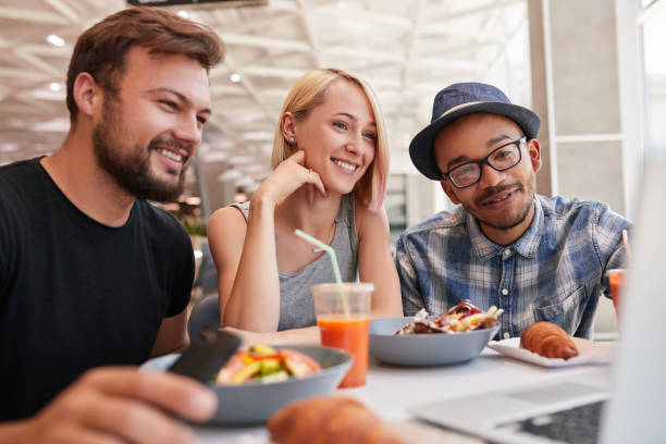 istock Diverse friends watching video in restaurant 1475819169