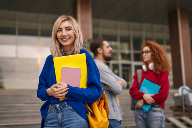 istock Happy female student outside college building 1475819324