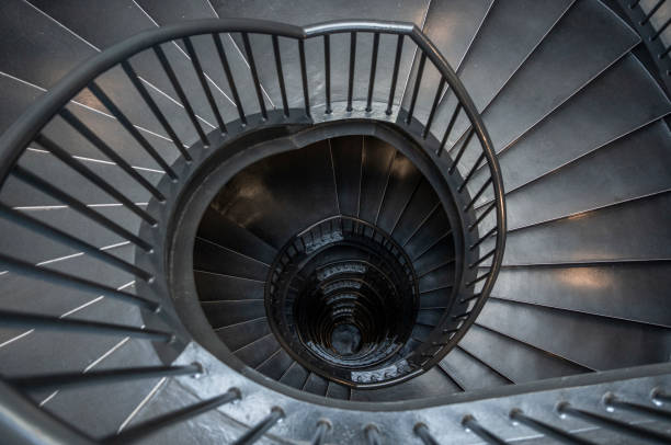 istock Metallic staircase spiraling down floors in a modern building 1475819708