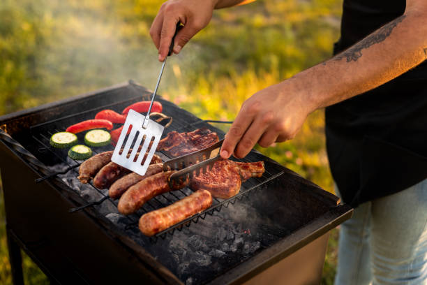istock Crop man grilling meat and vegetables during barbecue 1475820555