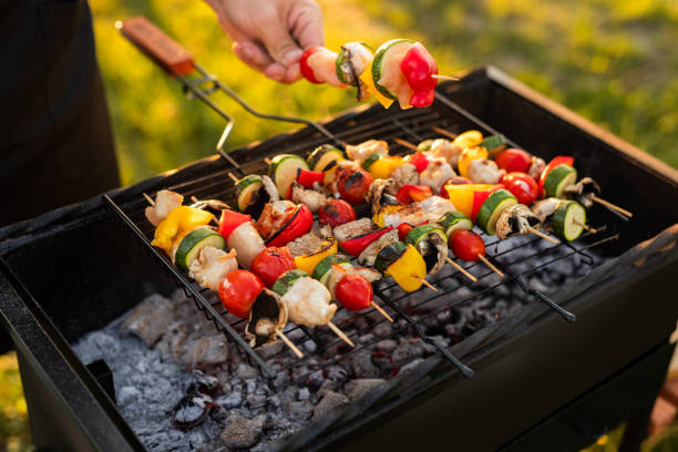 istock Crop man preparing skewers on grill 1475820619