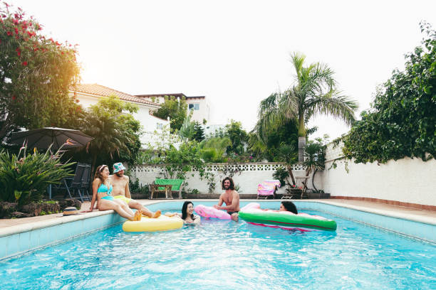 istock Happy people having fun inside swimming pool - Main focus on left girl face 1475822411