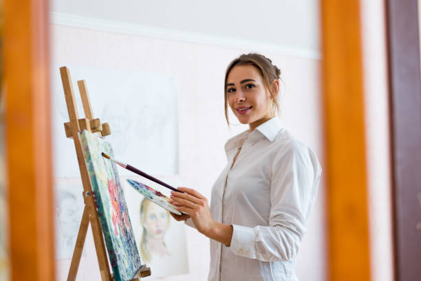 istock Young nice artist girl is looking at the camera 1475822713