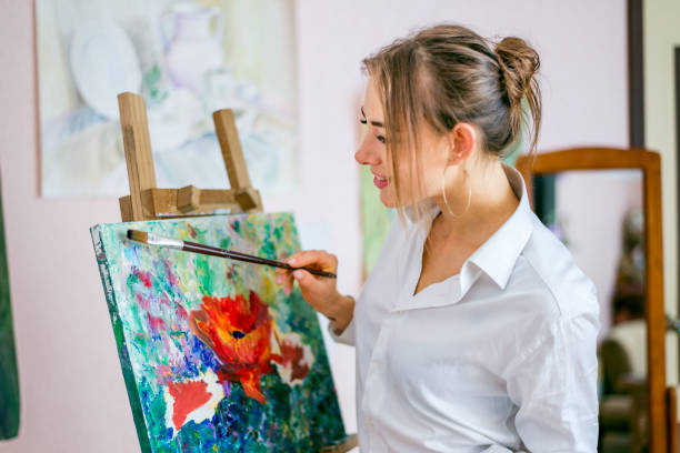 istock Young artist lady is painting 1475822729