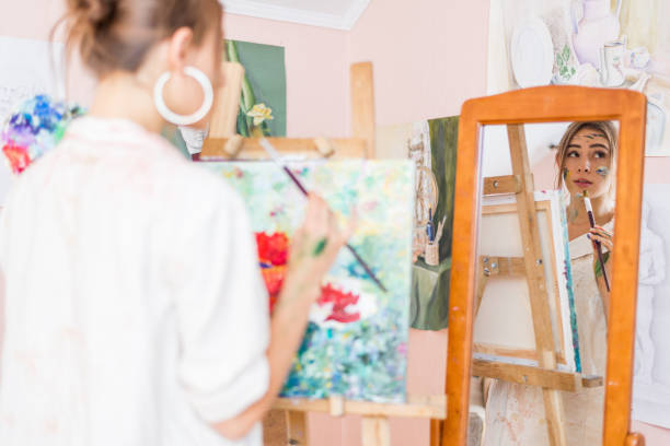 istock Young lady is painting 1475822822
