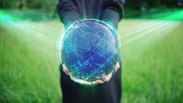 Person holding a rotating planet Earth globe hologram in a hand. Communication across the world