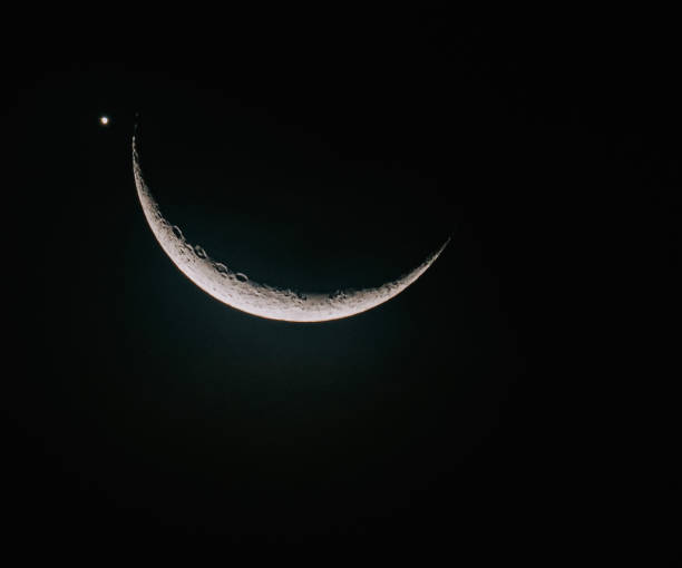 Crescent Moon with Venus planet beside at night