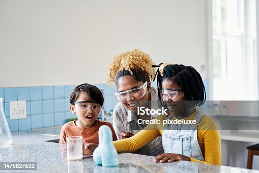 istock Kids science, happy teacher and children experiment excited in a classroom having fun with learning. Young scientist knowledge, assessment and helping with youth education research in a school class 1475827632