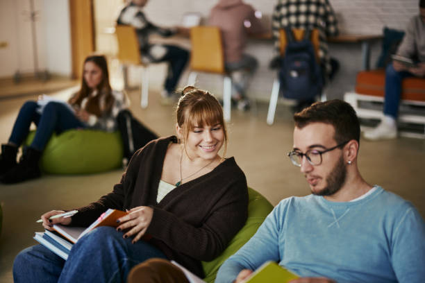 istock Happy couple of students learning at casual classroom. 1475829354