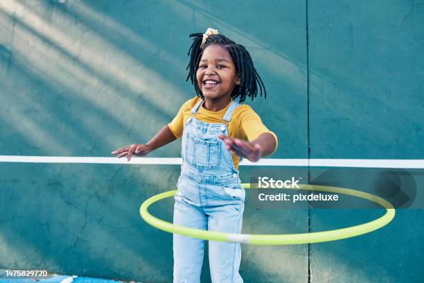 Happy Playing And Portrait Of A Child With A Hula Hoop For Fitness Practice And Hobby Smile Carefree And An African Girl With A Toy For Happiness Playtime And Break On A School Playground Stock Photo - Download Image Now
