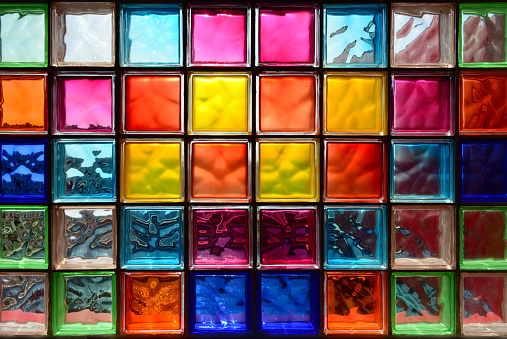 Colorful wall of square of decorative glass bricks - Translucent glass blocks background pattern.
