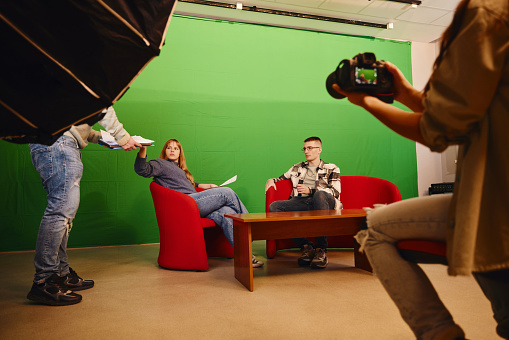 Young students recording a show in a studio. Copy space.