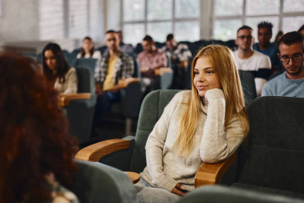 istock Smiling female student attending a lecture in amphitheater. 1475831242