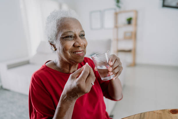 istock Elderly woman taking medicine 1475832063