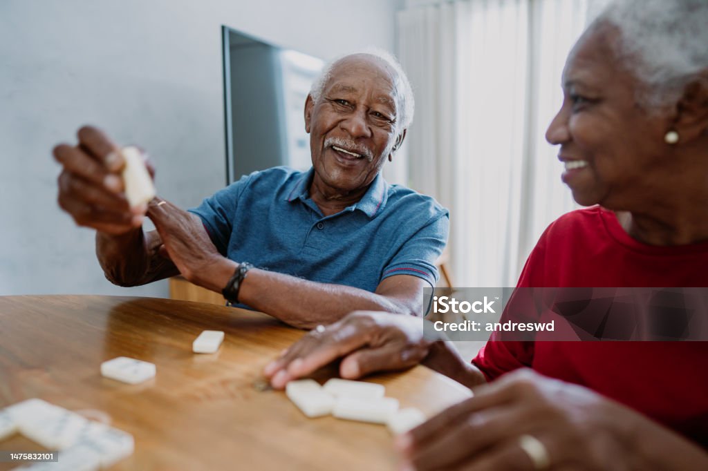 Senior couple playing dominoes Senior Adult Stock Photo
