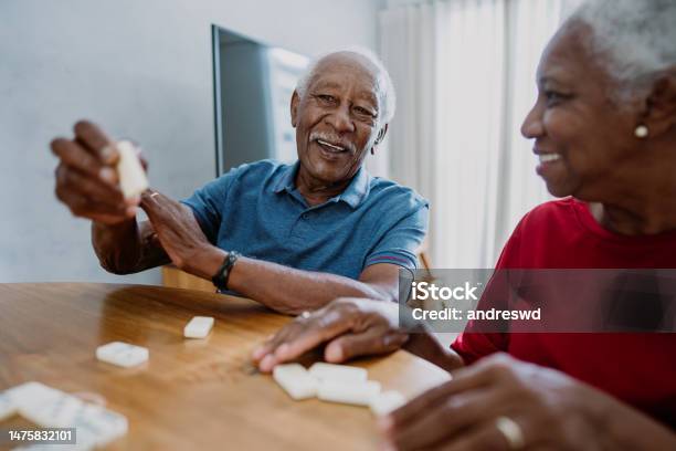 Senior Couple Playing Dominoes Stock Photo - Download Image Now - Senior Adult, Board Game, Playful