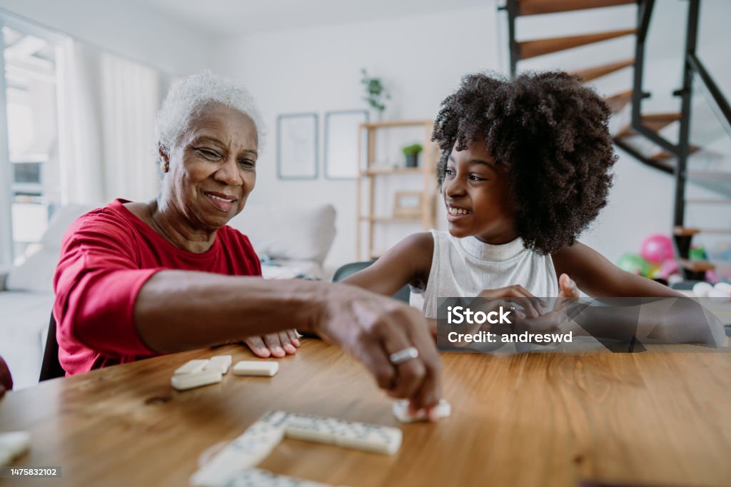 Grandmother playing dominoes with her granddaughter Grandmother Stock Photo