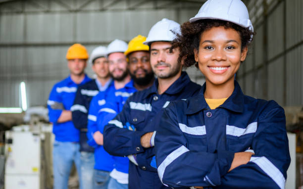 istock Group of professional engineers workers smiling to camera at factory 1475832826