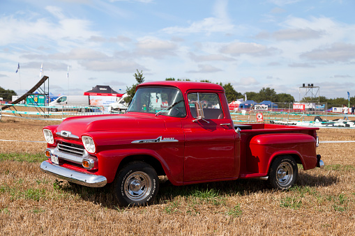 Pleyber-Christ, France - August, 28 2022: Red 1958 Chevrolet 31 Apache pick-up truck known as Task Force.