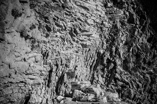 Background from natural limestone relief. Irregular stone surface for publication, design, poster, calendar, post, screensaver, wallpaper, card, cover, website. Gray toned high quality photography
