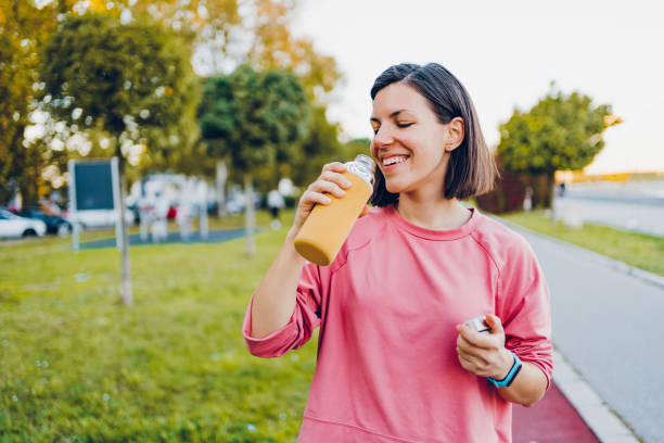 istock A young woman drinks water after running 1475835265