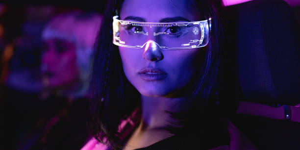 Female group portrait of two women who using eyeglasses for virtual reality in car. Neon light concept photography, futuristic photo with multi-color lighting indoors the vehicle. Girl and neural networks, people and technology for communication. retrato grupal femenino de dos mujeres que usan anteojos para realidad virtual en el automóvil. fotografía conceptual de luz de neón, foto futurista con iluminación multicolor en el interior del vehículo. redes neuronales y de niñas, personas y tecno