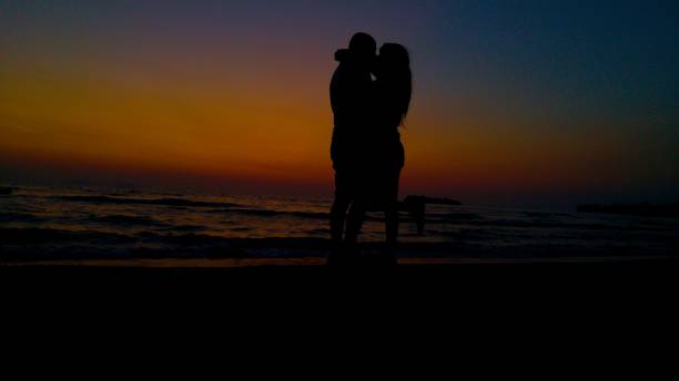 istock Love silhouette at sunset on the beach 1475837368