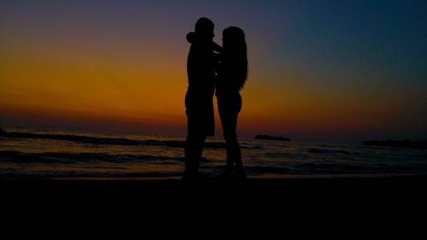istock Love silhouette at sunset on the beach 1475837386