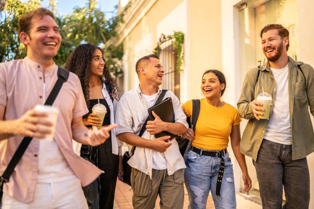 istock Happy young friends talking while walking on the street 1475840265