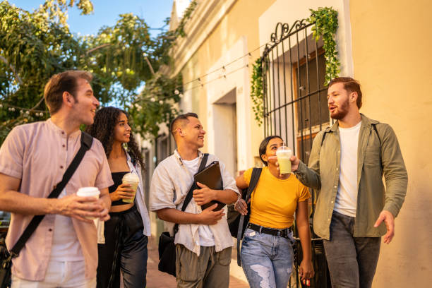 istock Young friends talking while walking on the street 1475840277