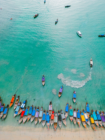 Traditional wooden dhow boats ashore on tropical sandy Nungwi beach in the Indian ocean on Zanzibar, Tanzania