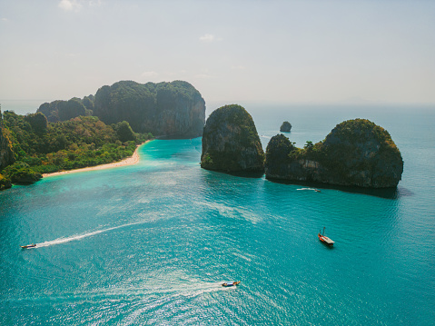 Scenic aerial view of speedboats near an island in Andaman sea