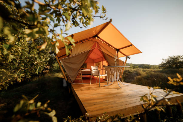 istock Cozy open glamping tent with light inside during sunset. Luxury camping tent for outdoor summer holiday and vacation. Lifestyle concept 1475841649