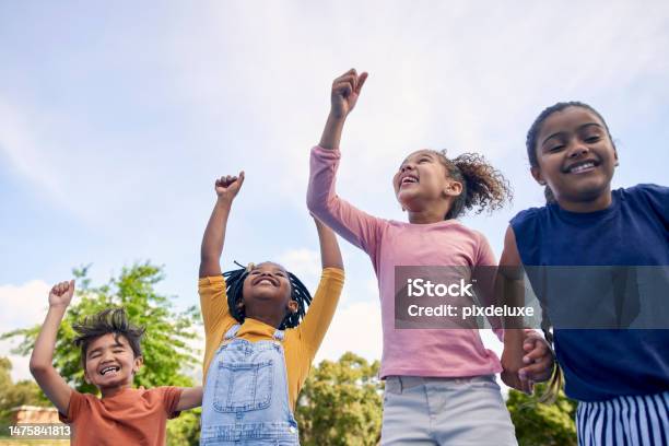 Children Energy And Diversity With Friends Cheering Together Outdoor While Having Fun During The Day Kids Freedom Or Celebration With A Girl And Boy Group Playing Or Bonding Outside In Summer Stock Photo - Download Image Now