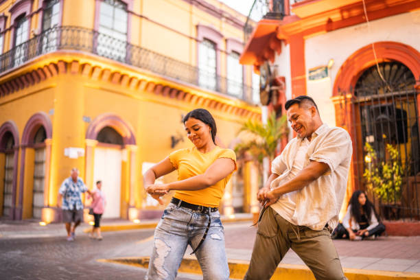 Young friends dancing together outdoors