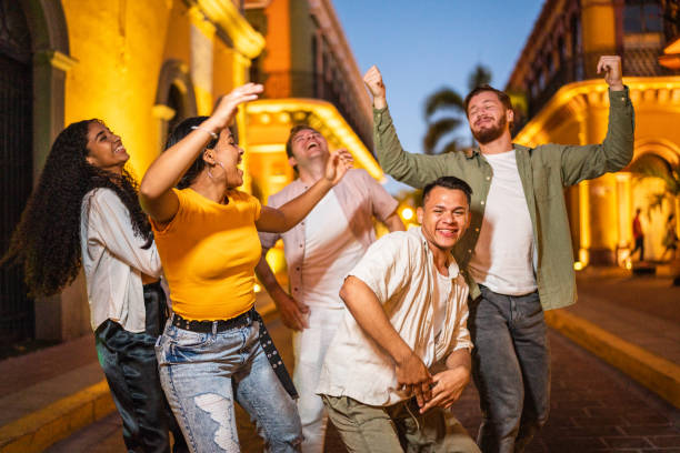 istock Happy friends dancing while walking on the street 1475846941