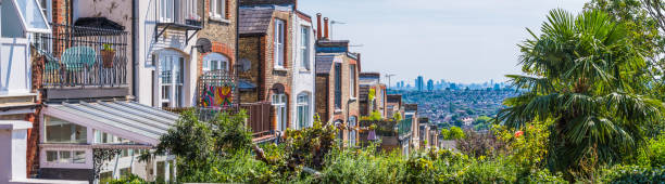 Suburban family homes overlooking cityscape skyscraper skyline panorama London UK stock photo