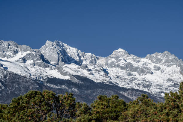 istock Snow mountains and woods under the blue sky 1475851498